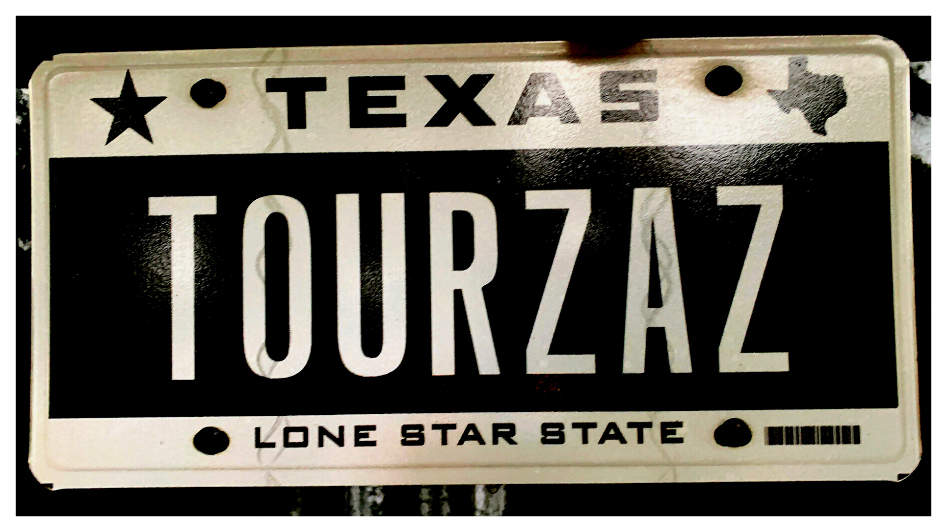 A Texas license plate that reads "TOURZAZ."